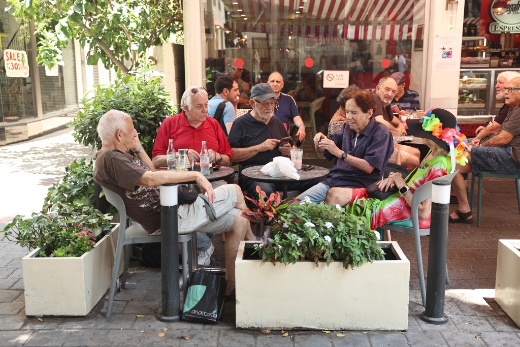 People on the terrace of a coffee shop in Tel Aviv. (AFP/File Photo)