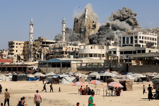 Smoke rises from the Al-Ghefari tower after it was hit by Israeli air strikes. REUTERS/Dawoud Abu Alkas 