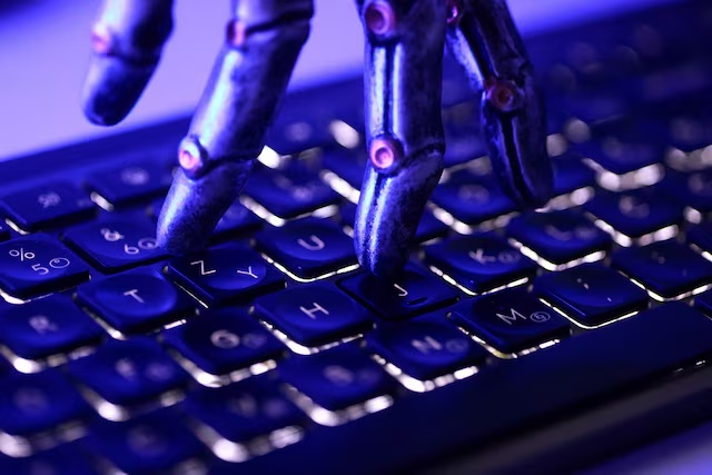 A keyboard and a robotic hand in this illustration taken June 5, 2026. REUTERS/Dado Ruvic/Illustration 