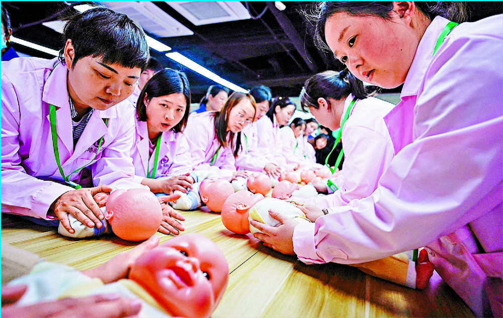 Women take part in a nursing skills class for confinement carers in Shanghai. REUTERS Women take part in a nursing skills class for confinement carers in Shanghai. REUTERS