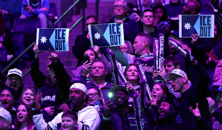 Fans hold signs to protest the presence of federal agents in Minneapolis during the game between the Warriors and Timberwolves. AFP