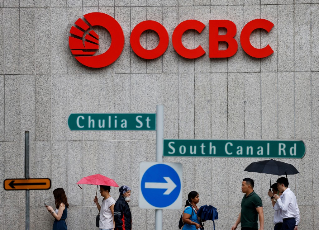 People pass an OCBC Bank signage in Singapore July 11, 2023. REUTERS/Edgar Su