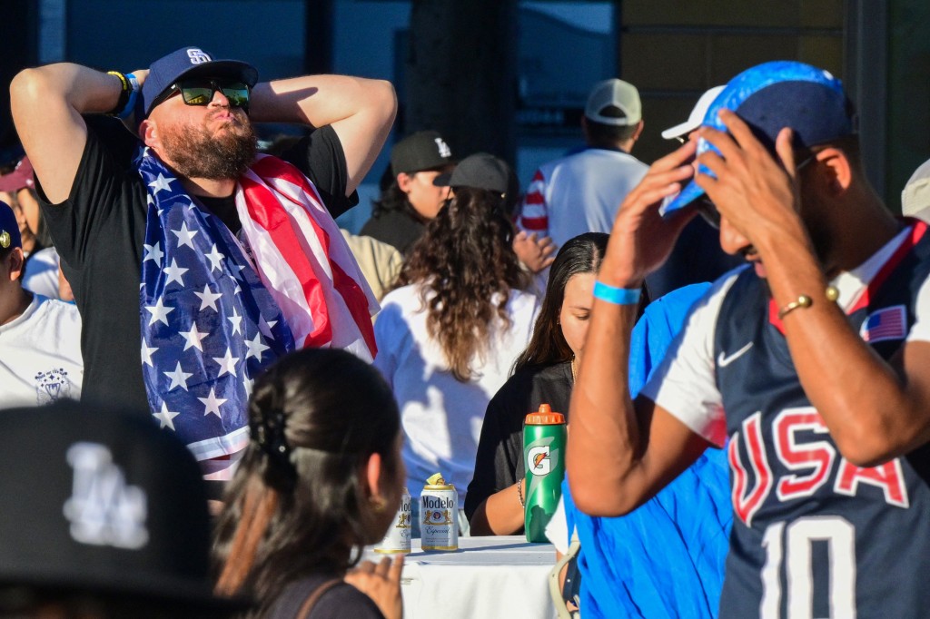 Fans react at the end of the 2026 World Cup round of 16 match between USA and Belgium at the Pasadena Civic Auditorium Plaza fan zone in Pasadena, California, on July 6, 2026. (Photo by Frederic J. Brown / AFP)