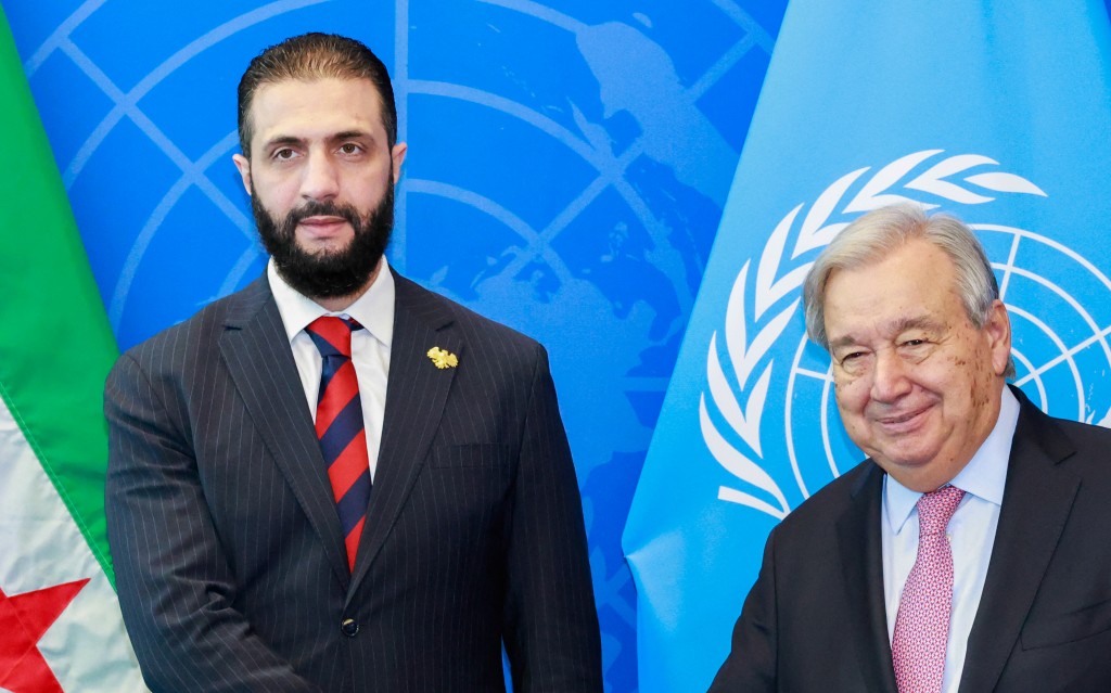 Syrian President Ahmed al-Sharaa (L) shake hands with UN Secretary-General Antonio Guterres (R) during the United Nations General Assembly at the UN headquarters in New York City on September 24, 2025. (Photo by Kena Betancur / AFP)