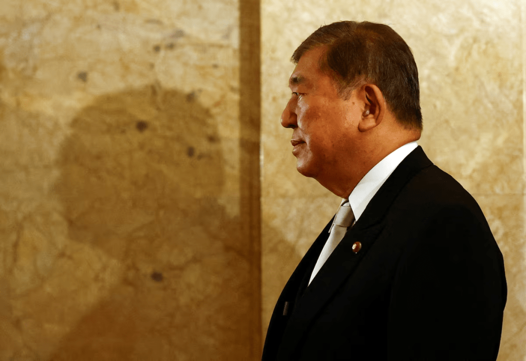 Japan's Prime Minister Shigeru Ishiba, wearing a formal attire, walks toward the upper house hall to attend an opening ceremony of the parliamentary session in Tokyo, Japan August 1, 2025. REUTERS/Issei Kato/File Photo