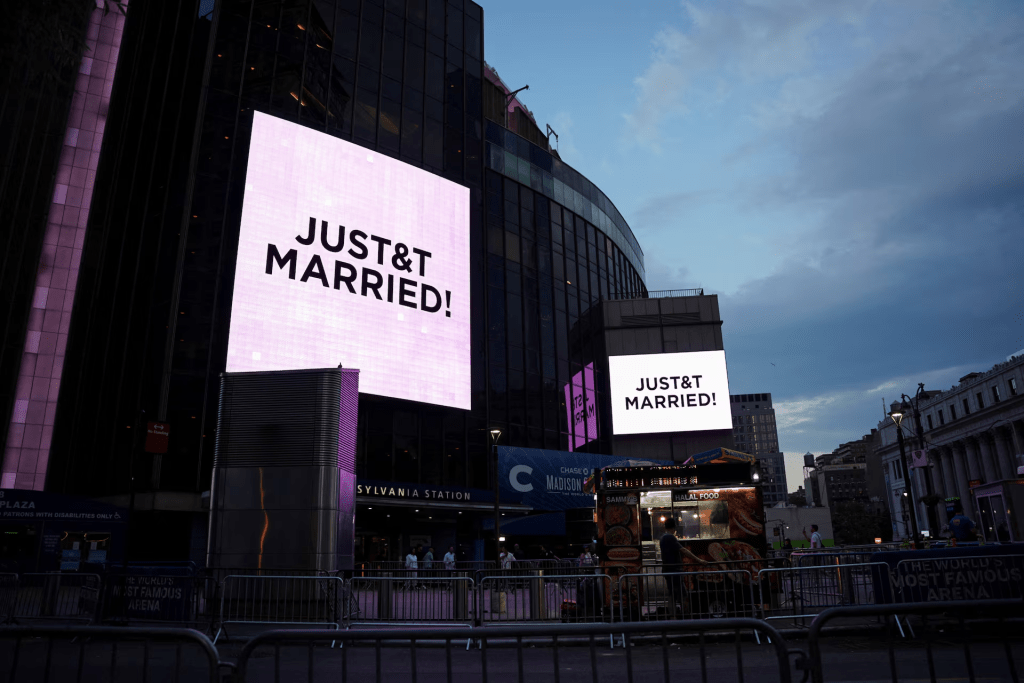 A screen displays a message referencing singer Taylor Swift and National Football League (NFL) player Travis Kelce outside Madison Square Garden, the venue for their reported wedding celebrations, in New York, U.S., July 3, 2026. REUTERS/Angelina Katsanis 