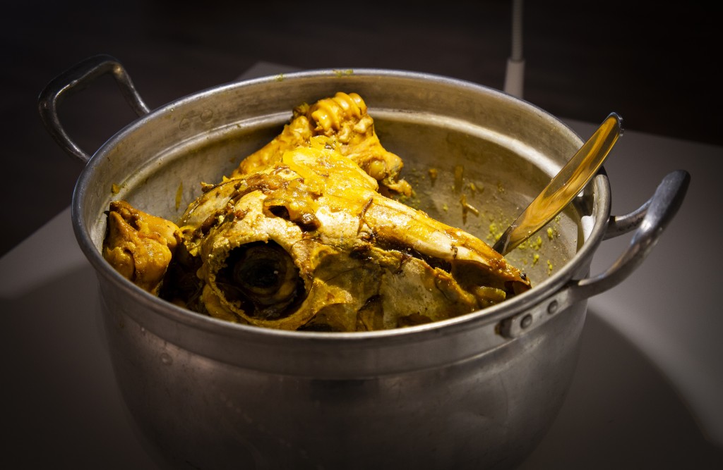 Iranian Kale Pache, a slow-simmered dish featuring a complete sheep’s head, hooves, and brain.
