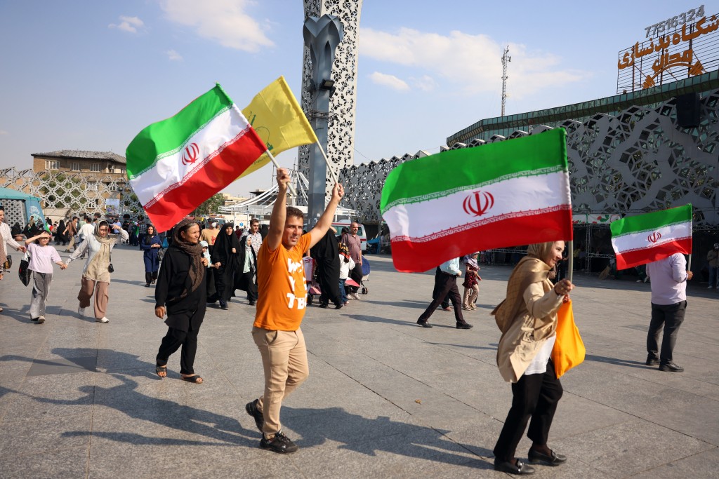 People wave Iran's national flags during a rally in support of the country's supreme leader Mojtaba Khamenei and commemorate Eid al-Ghadir in Tehran on June 4, 2026. (AFP)