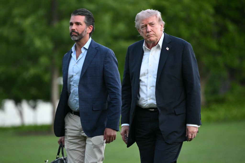 Photo by MANDEL NGAN / AFP. US President Donald Trump and Donald Trump Jr. walk on the south lawn toward the White House in Washington, DC, on May 3, 2026.