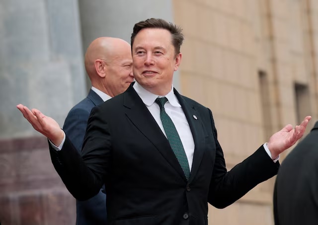 Elon Musk gestures as he leaves after attending a welcome ceremony for U.S. President Donald Trump with Chinese President Xi Jinping at the Great Hall of the People in Beijing, China, May 14, 2026. REUTERS/Evan Vucci