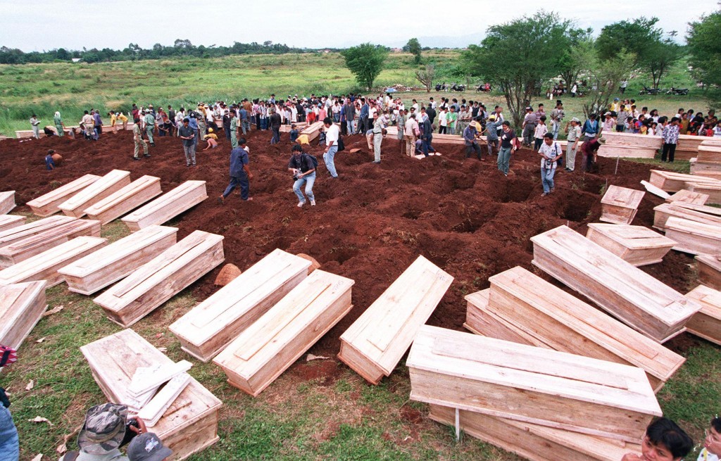 Coffins are laid around a mass grave after being brought by ambulances to Pondok Rangon cemetery in Jakarta on May 18, 1998. (AFP)