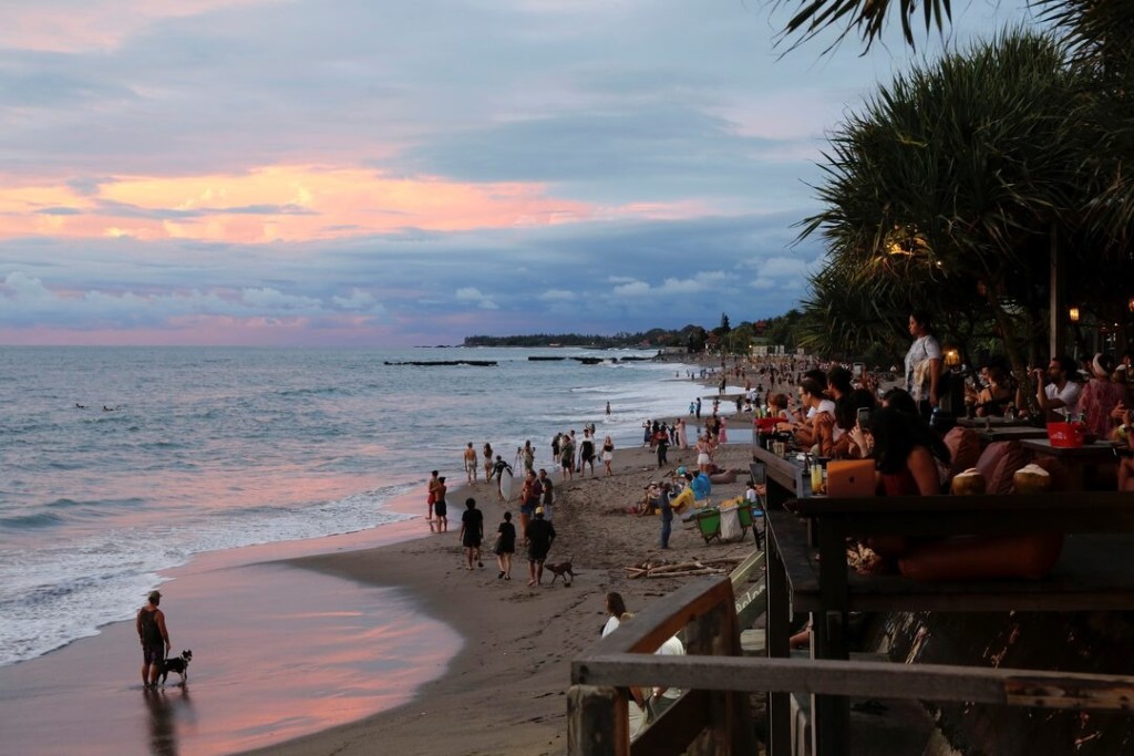 Tourists enjoy the sunset at Canggu beach amidst the coronavirus disease (COVID-19) pandemic in Bali, Indonesia, December 2, 2021. REUTERS/Johannes P. Christo