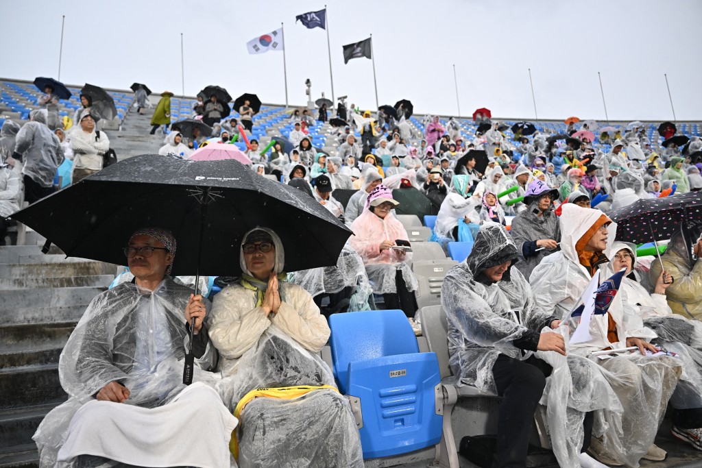 Spectators wait for the start of the Women's Asian Champions League semi-final football match between South Korea's Suwon FC Women and North Korea's Naegohyang Women's FC at Suwon Sports Complex in Suwon on May 20, 2026. (Photo by Pedro Pardo / AFP)
