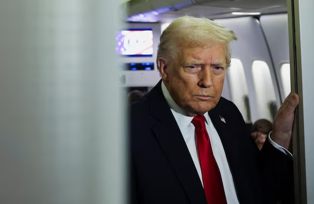 U.S. President Donald Trump looks on aboard Air Force One during travel to Palm Beach, Florida, from Joint Base Andrews, Maryland, U.S., November 25, 2025. REUTERS/Anna Rose Layden 