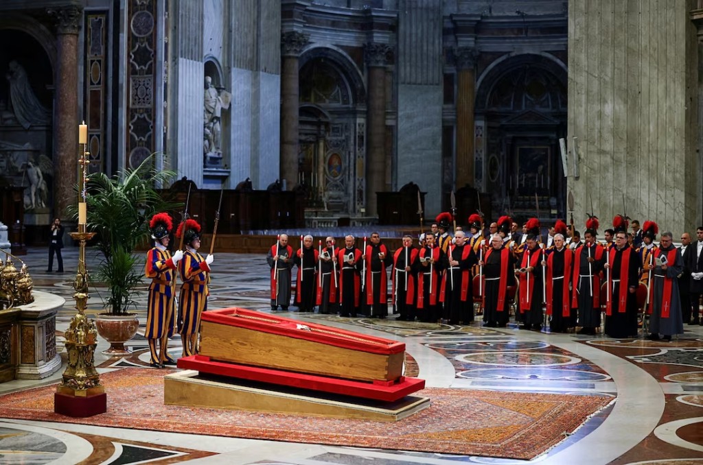 Members of the Swiss Guard stand next to the coffin containing Pope Francis' body, on the day of the translation of his body, in St. Peter's Basilica at the Vatican, April 23, 2025. (Reuters)