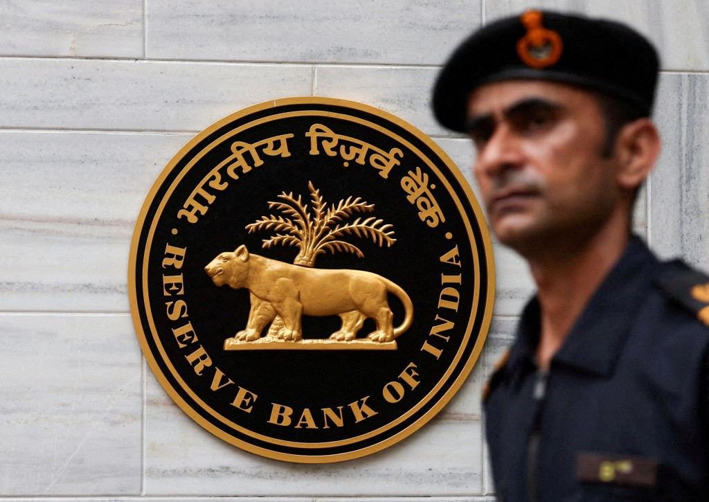 A man walks past the Reserve Bank of India (RBI) logo outside its headquarters in Mumbai, India, June 6, 2025. REUTERS