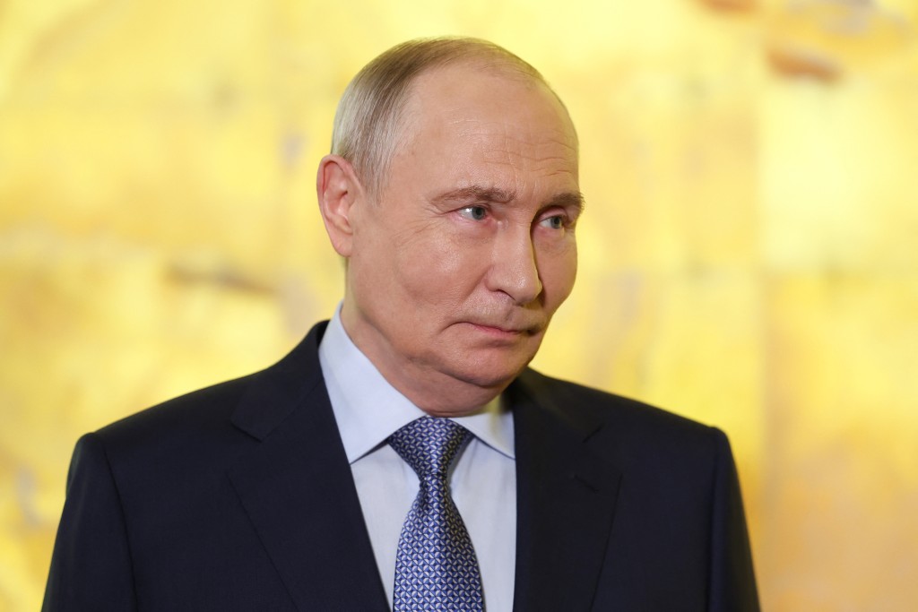 In this pool photograph distributed by the Russian state agency Sputnik, Russia's President Vladimir Putin meets with the media during the International United Cultures Forum at the Mariinsky Theatre in Saint Peter