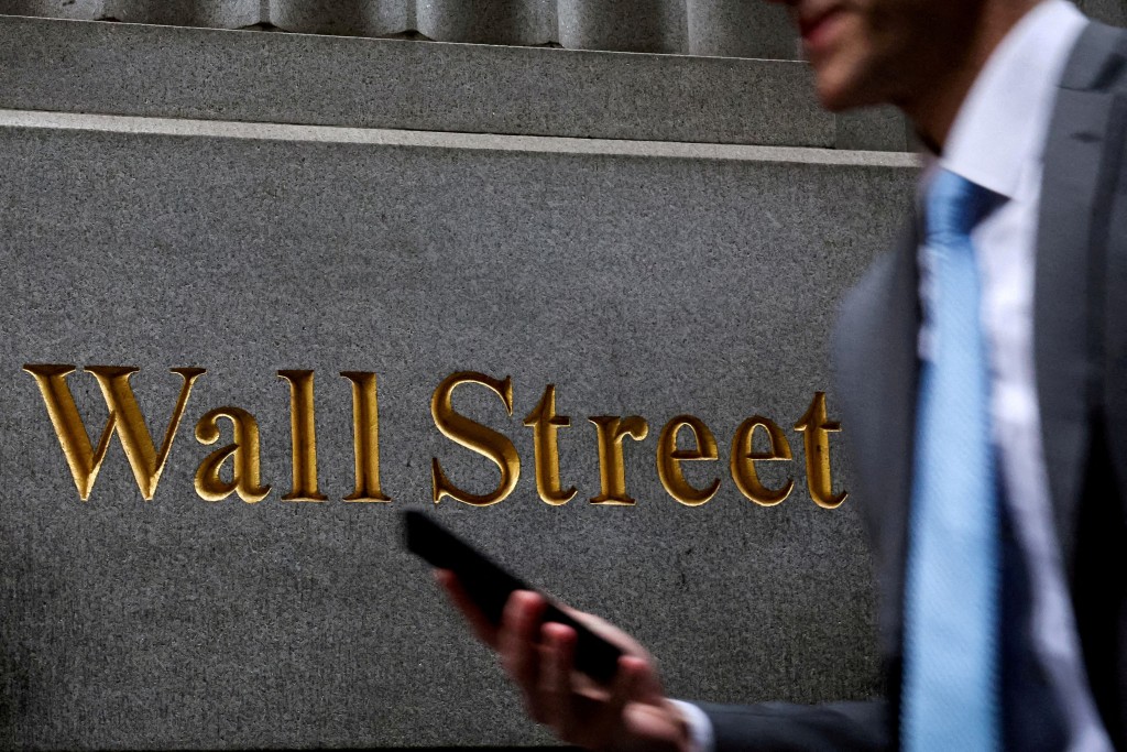 A man walks on Wall Street outside the New York Stock Exchange (NYSE) in New York City, U.S., April 7, 2025. REUTERS/Brendan McDermid//File Photo