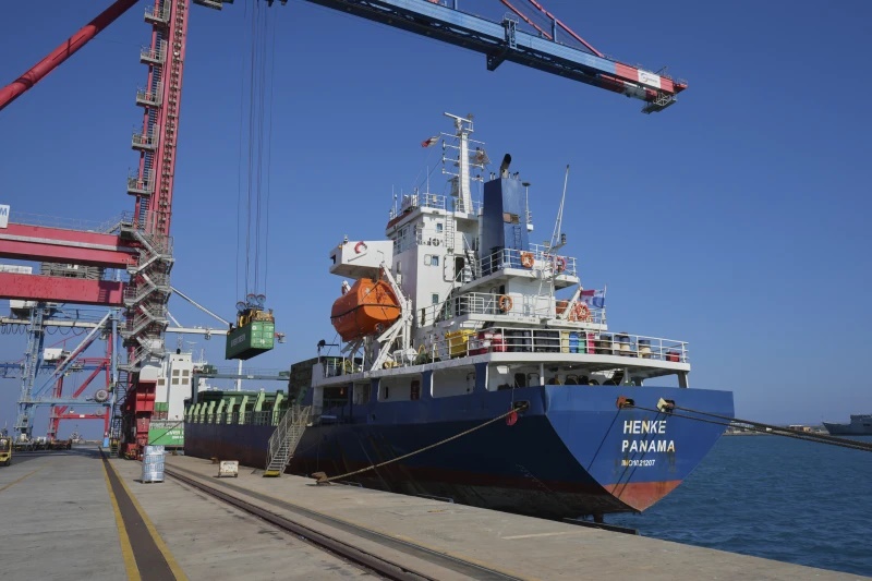 Containers loaded with humanitarian aid for the people of Gaza, including flour, pasta, baby food and canned goods, is being loaded aboard a Panamanian-flagged ship at Cyprus’ main port in Limassol, on Monday, Aug. 18, 2025. (AP Photo/Petros Karadjias)
