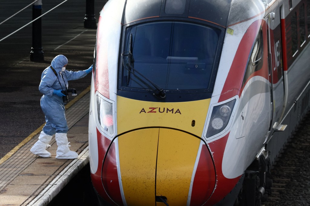 A forensic officer inspects the London North Eastern Railway (LNER) train where a series of stabbings took place, at a platform at Huntingdon Station, near Cambridge, Britain, November 2, 2025. (Reuters)
