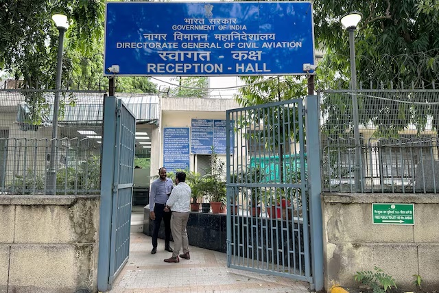 People stand outside the entrance to the headquarters of the Directorate General of Civil Aviation in New Delhi, India, July 21, 2026. REUTERS/Abhijith Ganapavaram