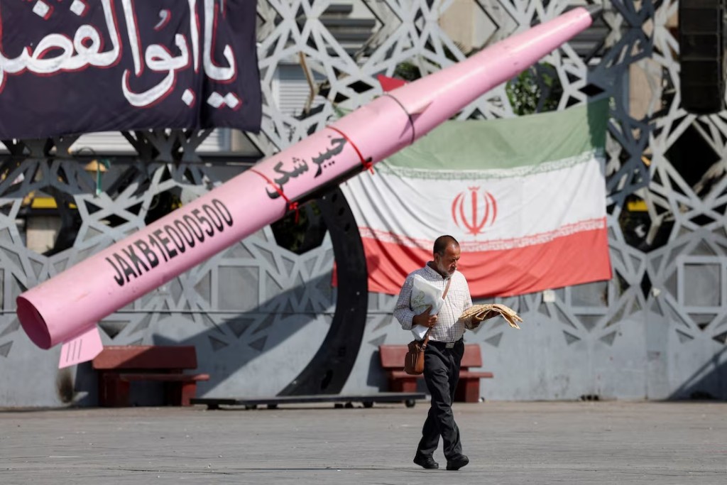A man walks next to a symbolic mockup of an Iranian missile and an Iranian flag at Imam Hussein Square in Tehran, Iran, July 12, 2026. Majid Asgaripour/WANA (West Asia News Agency) via REUTERS/File Photo