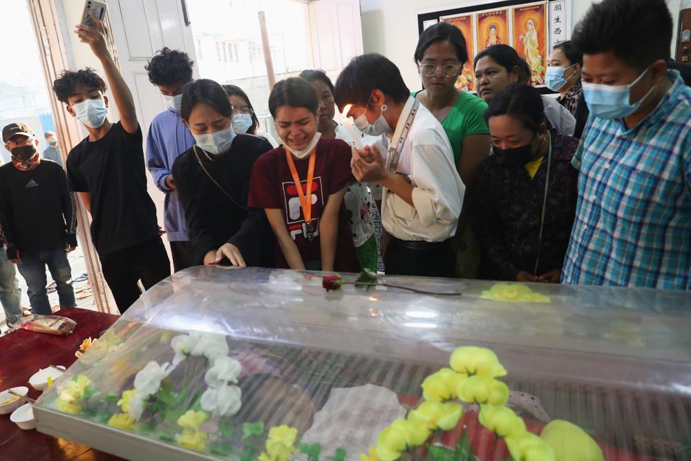  In this Wednesday, Mar. 3, 2021 file photo, people mourn over the body of 19-year-old Kyal Sin, also known as Angel, a university student who was shot in the head during an anti-military takeover rally in Mandalay, Myanmar. Authorities released a death certificate saying the bullet that killed her didn’t match the caliber used by police, that it came from the wrong direction for security forces to be responsible, and blamed protesters for her death. However, local news reports and social media accounts said security forces were firing live rounds.