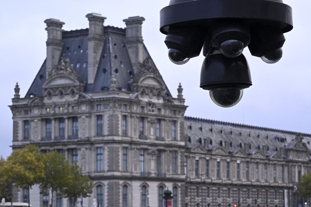 This photographs shows city's CCTV cameras with the Louvre museum in the background a day after thieves stole eight priceless royal pieces of jewellery from the Louvre Museum, in Paris on October 20, 2025. (AFP)