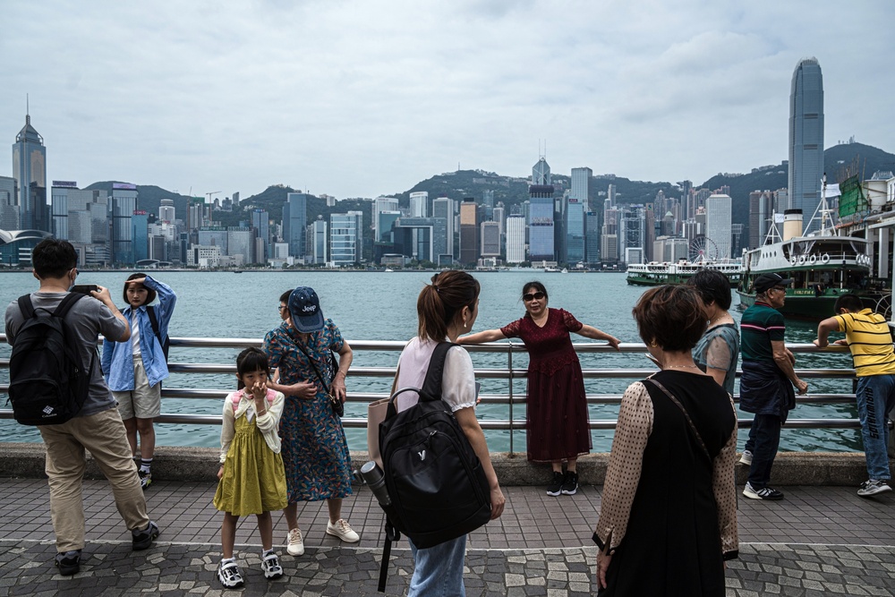 Tourists on the promenade in the Tsim Sha Tsui area of Hong Kong. Photo by Bloomberg. Tourists on the promenade in the Tsim Sha Tsui area of Hong Kong. Photo by Bloomberg.
