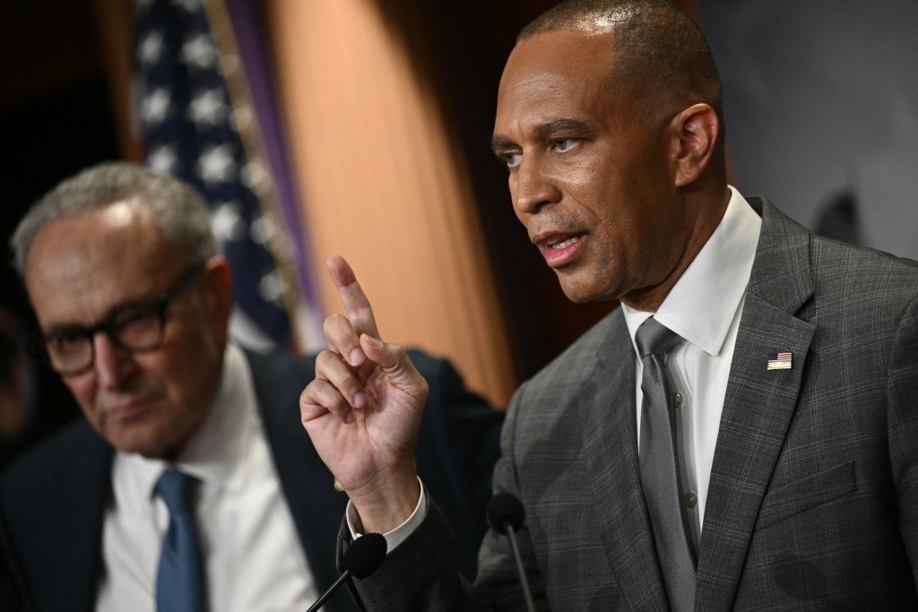 US House Minority Leader Hakeem Jeffries (R), D-NY, speaks to reporters as Senate Minority Leader Chuck Schumer, D-NY, looks on at the US Capitol in Washington, DC, on September 29, 2025, after meeting with Republican Leadership and US President Donald Trump about a potential government shutdown.  (Photo by Brendan SMIALOWSKI / AFP)