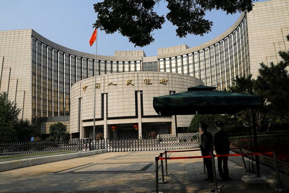 Paramilitary police officers stand guard in front of the headquarters of the People's Bank of China. (Reuters) Paramilitary police officers stand guard in front of the headquarters of the People's Bank of China. (Reuters)
