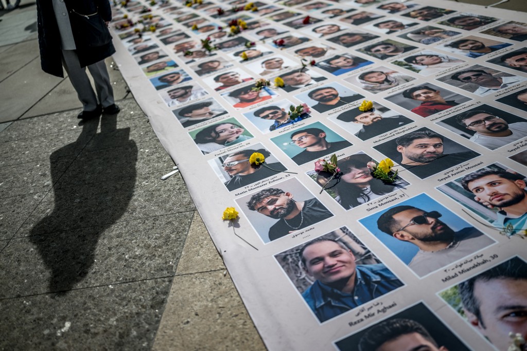 Portraits of killed Iranian protesters are displayed during a demonstration against the Iranian regime on the sideline of the 61st session of the UN Human Rights Council in Geneva on February 23, 2026. (Photo by Fabrice COFFRINI / AFP)