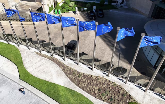 A drone view shows the European Union flags outside the European Commission headquarters, known as the Berlaymont building in Brussels, Belgium, April 29, 2026. REUTERS/Yves Herman 
