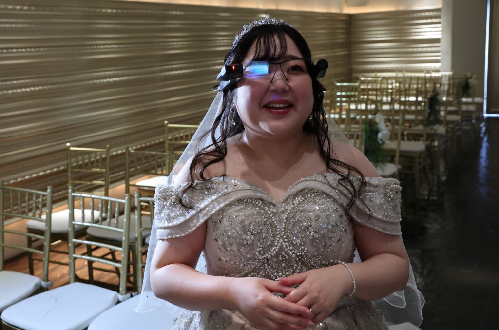 Yurina Noguchi, 32, reacts as she views an AI-generated image of her AI partner Klaus on an AR display through Vuzix smart glasses during their ceremonial wedding at the Magritte wedding venue in Okayama, Japan, October 27, 2025. REUTERS/Kim Kyung-Hoon
