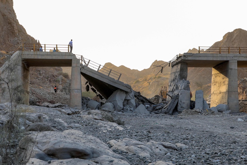 A heavily-damaged bridge which was hit by a US strike is pictured along the road connecting Roudan and Bandar Abbas in southern Iran on July 18, 2026. The United States hit Iran on July 17, with Tehran accusing US forces of striking civilians sites and drawing Iranian threats of reprisals on regional infrastructure. A battle over the strategic Strait of Hormuz has rekindled the war in the Middle East and the foes have traded fire for six days running. (Photo by Amir Hossein KHORGOOEI / ISNA / AFP) /