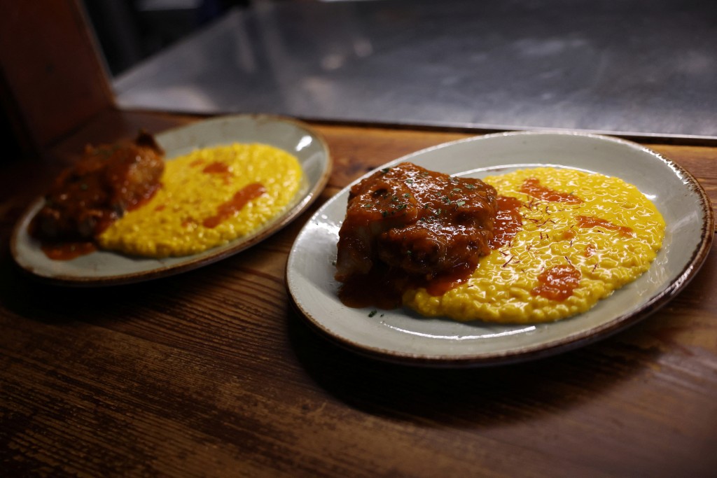 Risotto con ossobuco is ready to be served at Cantina della Vetra restaurant as Italian cuisine awaits a crucial UNESCO decision that could recognise it as an Intangible Cultural Heritage of Humanity in Milan, Italy, December 6, 2025. REUTERS/Claudia Greco