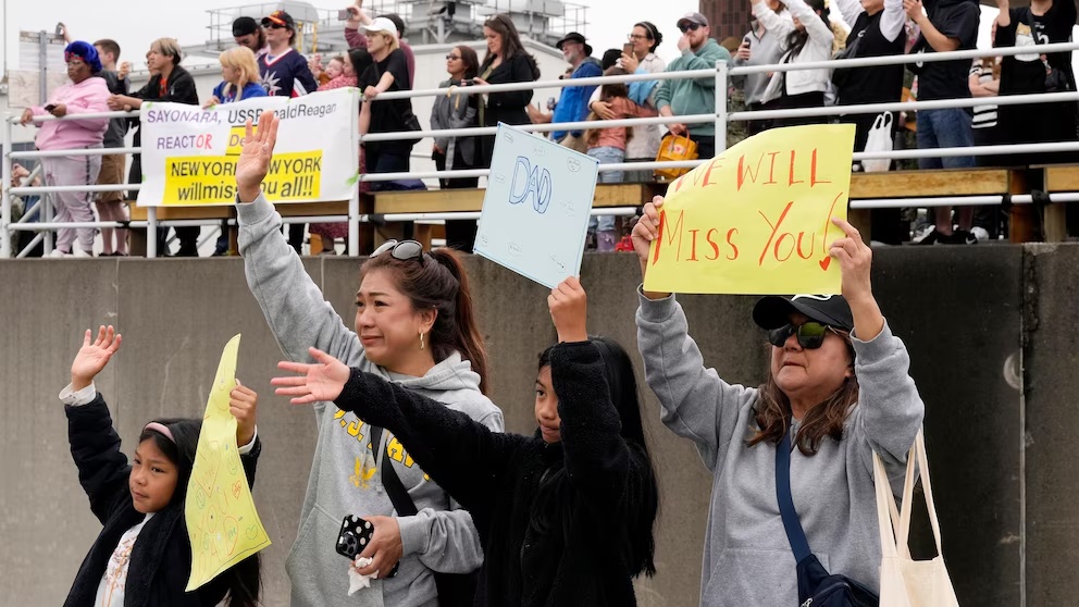 Family members and friends of the crew of the U.S. navy aircraft carriers USS Ronald Reagan (CVN-76) see off at the U.S. navy's Yokosuka base Thursday, May 16, 2024, in Yokosuka, south of Tokyo. This is the ship's final departure from Yokosuka before transiting back to the United States. (AP Photo/Eugene Hoshiko) Family members and friends of the crew of the U.S. navy aircraft carriers USS Ronald Reagan (CVN-76) see off at the U.S. navy's Yokosuka base Thursday, May 16, 2024, in Yokosuka, south of Tokyo. This is the ship's final departure from Yokosuka before transiting back to the United States. (AP Photo/Eugene Hoshiko)