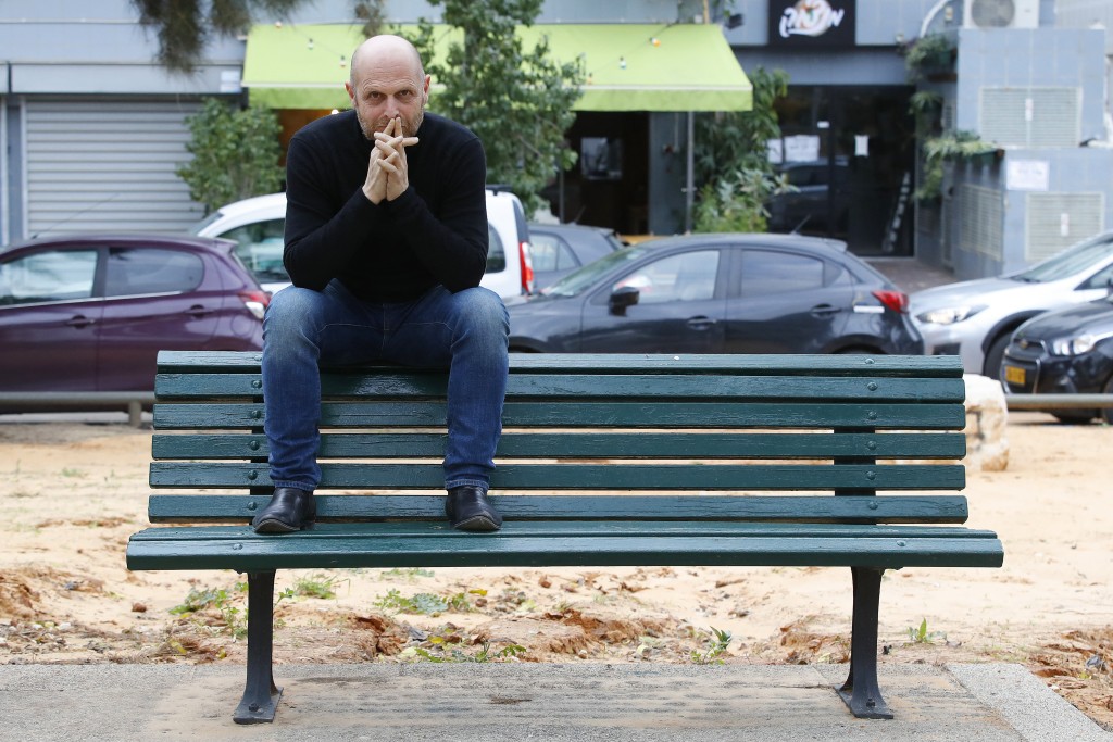 Israeli screenwriter Hagai Levi poses for a picture during an interview with AFP on January 7, 2020 in the Mediterranean coastal city of Tel Aviv. After cementing his reputation as a top producer in the US, Israel's Hagai Levi has sparked controversy back home with his latest TV series "Our Boys". (Photo by JACK GUEZ / AFP)