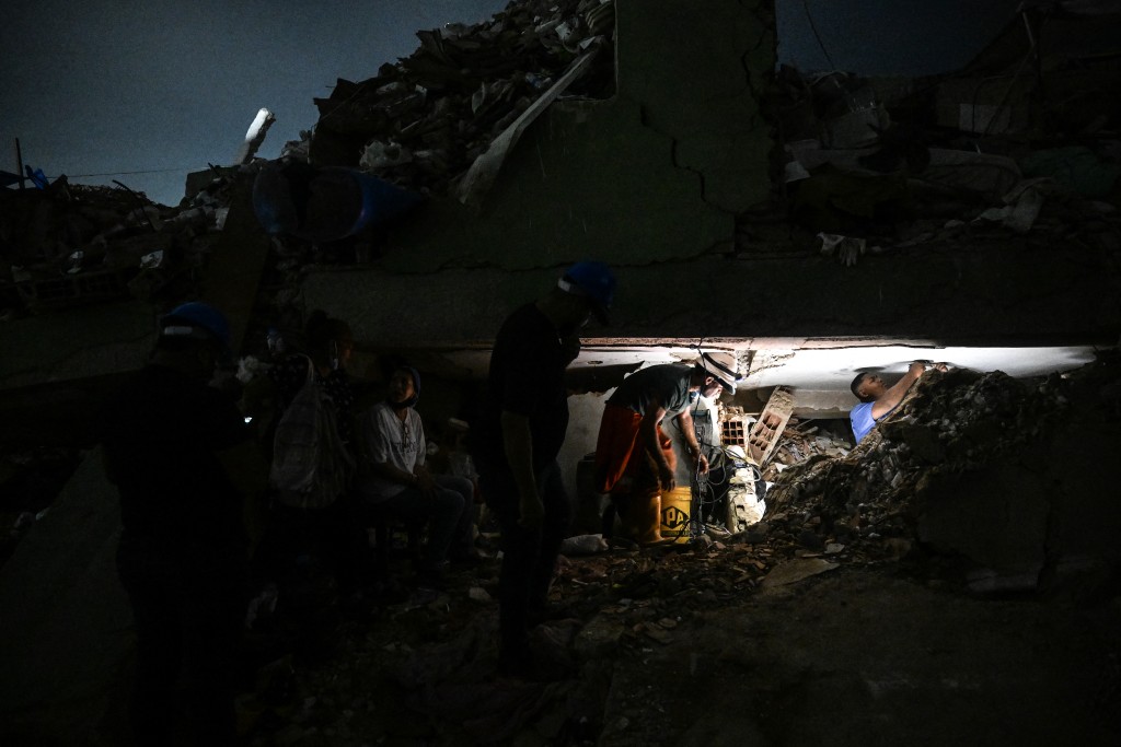 Photo by JUAN BARRETO / AFP Rescue volunteers take part in the search for bodies amid the rubble 46 days after the 7.2 and 7.5 earthquakes in La Guaira, Venezuela on August 9, 2026.