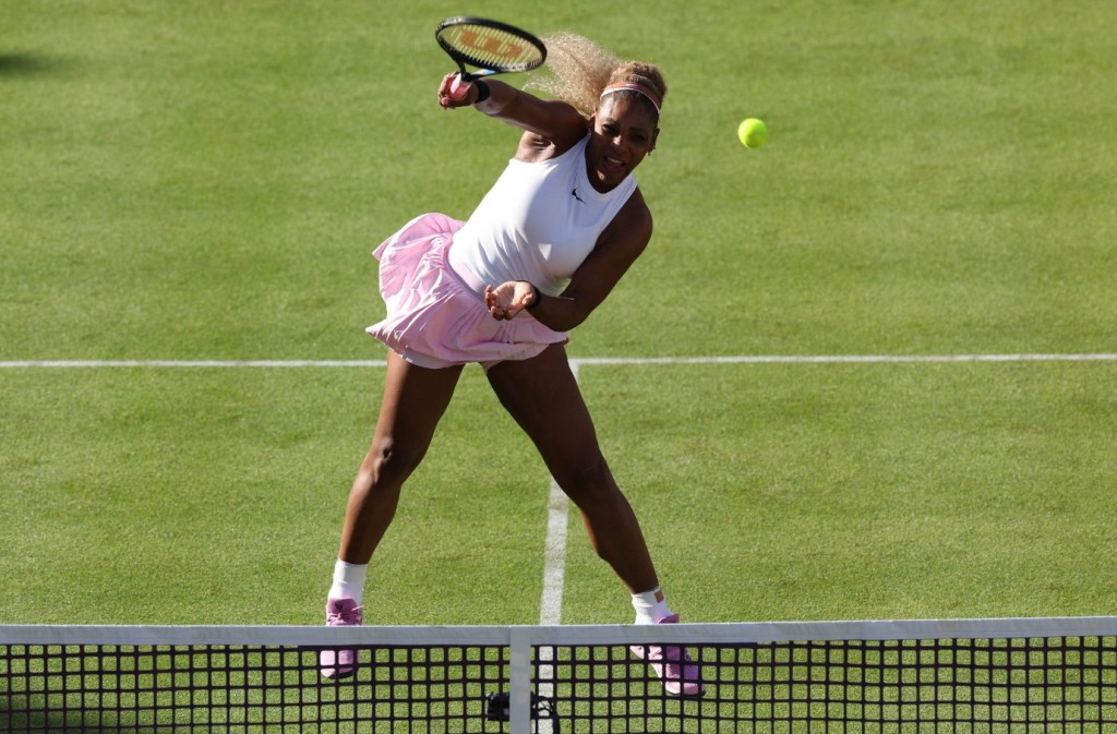 Serena Williams hits a return during a doubles match at Queen's Club. AFP