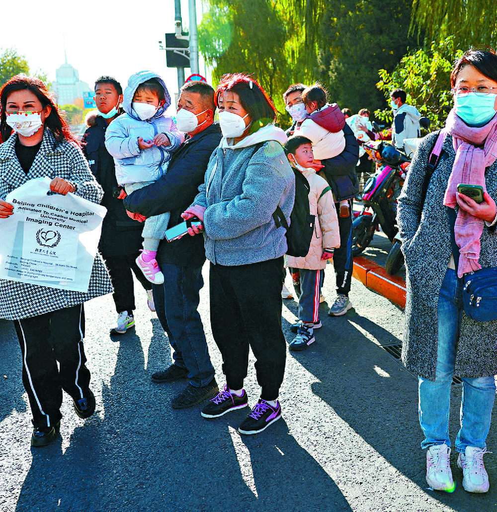 Children wait outside a hospital in Beijing to be treated. Children wait outside a hospital in Beijing to be treated.