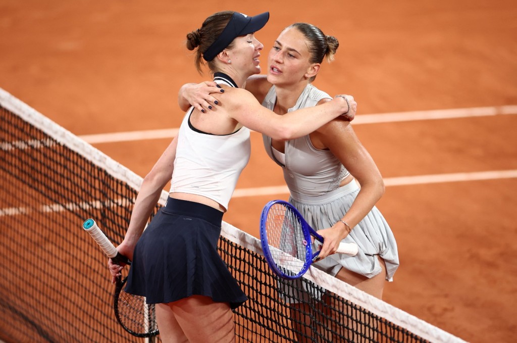 Marta Kostyuk and Elina Svitolina, left, embrace after their all-Ukrainian quarter-final. REUTERS
