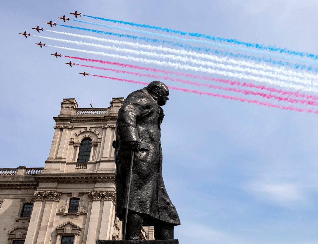 The British Royal Air Force Red Arrows conduct a fly past over the statue of former British Prime Minister Winston Churchill in London, Britain May 8, 2020. SAC Connor Tierney/UK Ministry of Defence/Crown Copyright 2020/Handout via REUTERS