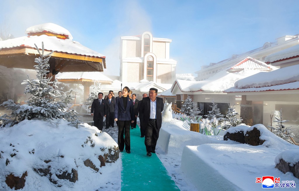 This picture taken on December 20, 2025 and released by North Korea's official Korean Central News Agency (KCNA) via KNS on December 23, 2025 shows North Korean leader Kim Jong Un (R) and his daughter Ju Ae (L) inspecting the Milyong Hotel, which was recently completed in the Samjiyon tourist district of Ryanggang Province. (Photo by KCNA VIA KNS / AFP)