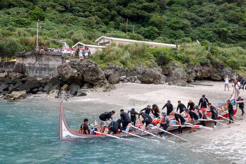 Tao indigenous rowers jump into a traditional wooden canoe named Ovayan, or "Golden Friendship," as they prepare to paddle to the Philippines' Batanes Islands, on Orchid Island, Taiwan, June 15, 2026. REUTERS/Ann Wang