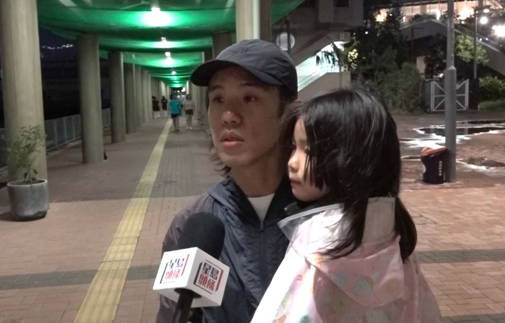 Mr. Chow brought his daughter downstairs during the relatively safe conditions to experience the weather