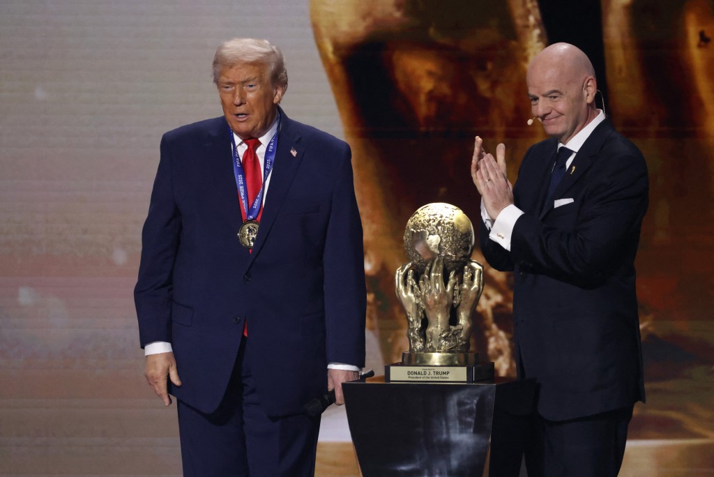 Dec 5, 2025; Washington, District of Columbia, USA; FIFA president Gianni Infantino presents United States President Donald Trump with the FIFA Peace Prize during the FIFA World Cup 2026 Final Draw at John F. Kennedy Center for the Performing Arts. Mandatory Credit: Amber Searls-Imagn Images