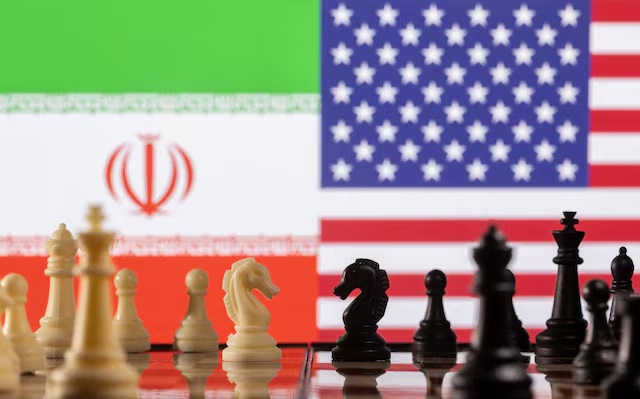 Chess pieces are seen in front of displayed Iran's and U.S. flags in this illustration taken January 26, 2022. REUTERS/Dado Ruvic/Illustration