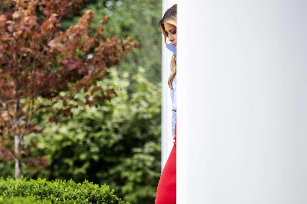 US First Lady Melania Trump walks out between the columns of the colonnade as she arrives to host an event with IndyCar and FOX Sports to expand academic opportunities for individuals transitioning from foster care, in the Rose Garden of the White House, in Washington, DC, on August 20, 2026. (Photo by Jim WATSON / AFP)