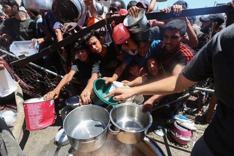 Starving Palestinians seek desperately needed food aid in Nuseirat, central Gaza Strip, July 20, 2025 [Ramadan Abed/Reuters]